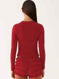 Back detail of a slim-fit red ribbed long-sleeve top and matching ruffled shorts