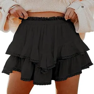 Detail of the black ruffled tiered mini skirt with delicate lace trim at the hem.