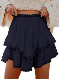 Detailed view of bohemian tiered ruffled mini skirt with lace eyelet trim in navy blue