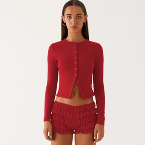 Front view of red slim fit button-up cardigan with matching ruffled shorts