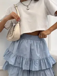 Detailed view of a light blue high-waisted tiered mini cake skirt with dotted texture