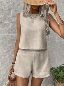 Detail shot of women's beige sleeveless top and shorts set in linen-like fabric.
