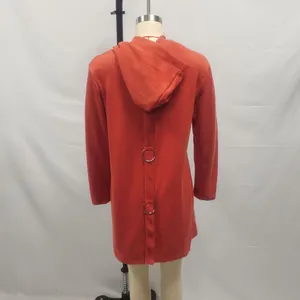 Back detail of a red hooded coat featuring decorative vertical strap and metal rings