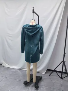 Detail showing the back design of a teal fleece hoodie with metal rings and strap.