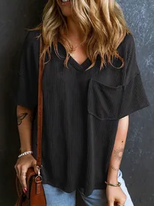 Dettaglio della maglia nera da donna con scollo a V, trama a costine e taschino sul petto.