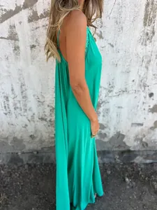 Side view of a long emerald green camisole dress with lace detailing at the neckline.