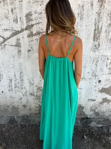 Detailed back view of a vibrant green spaghetti strap maxi dress for summer wear