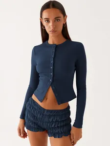Detail view of navy blue ribbed button-up cardigan with matching ruffled shorts set