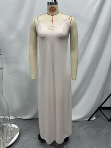 Detailed close-up view of a long pink silk-like lace slip dress displayed on a mannequin