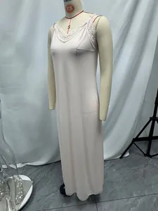 Close-up of a long pink satin slip nightgown with delicate lace trim on the V-neckline.