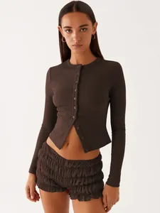 Detailed close-up of dark brown ribbed knit button-up cardigan with slim fit design
