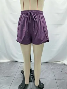 Close-up detail of women's purple 5-inch quick-dry running shorts with adjustable drawstring