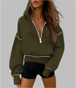 Detail view of women's olive green half-zip cropped hoodie with contrast stitching