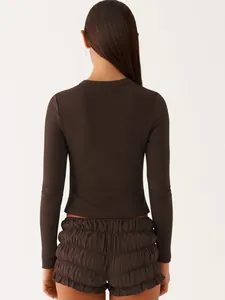 Back view of a dark brown ribbed slim-fit long-sleeve top and ruffled shorts set.