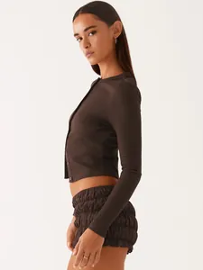 Side view of a brown slim-fit ribbed button-up cardigan and matching textured shorts