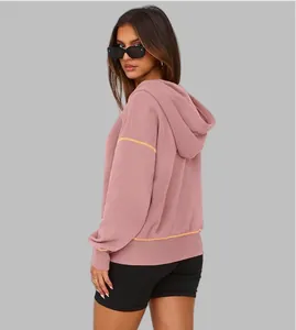 Back view of a pink half-zip hooded sweatshirt with contrasting yellow trim details.