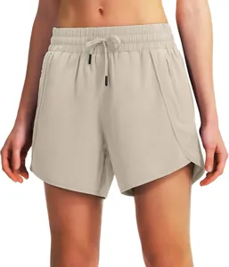 Detailed view of beige 5-inch quick-dry running shorts with zip pockets and drawstring waist
