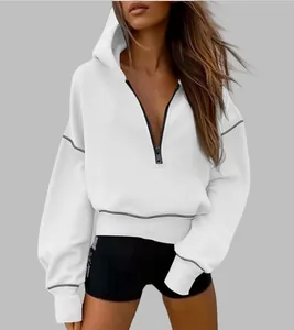 Close-up detail of a women's white half-zip cropped hoodie with contrast stitching