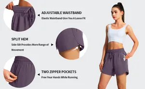 Detail view of purple women's athletic shorts with zipper pockets and split hem design.