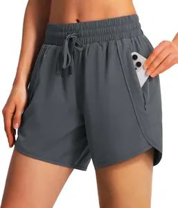 Detail view of women's grey running shorts showing a functional side pocket with a phone.