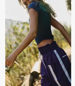Close-up view of Y2K high waist drawstring sports pants with purple side stripes