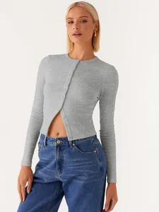 Close-up detail view of a grey ribbed slim fit cropped cardigan top with front buttons