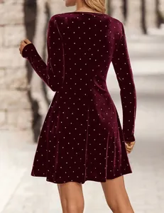 Detailed back view of a vintage burgundy velvet mini dress with silver studded polka dots.