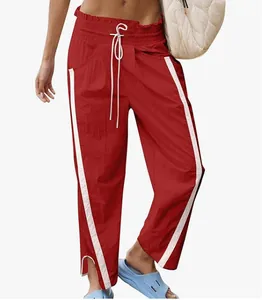 Red Y2K high waist drawstring sports pants with white side stripes and ankle slits