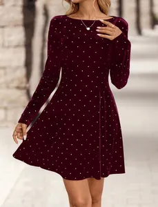 Close-up of elegant burgundy velvet mini dress with sparkling rhinestone polka dots and long sleeves.