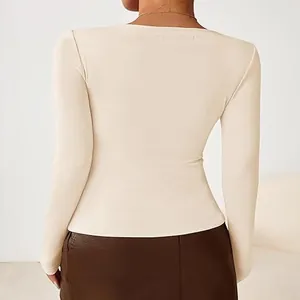Back view detail of a slim-fit cream long-sleeve base shirt with soft knit texture