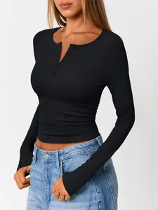 Detail of women's black ribbed long-sleeve top featuring buttoned henley neckline.