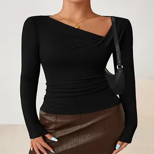 Close-up of slim fit black long-sleeve top with elegant irregular neckline detail
