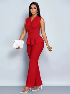 Full body view of an elegant red two-piece outfit featuring a peplum top and flared trousers.