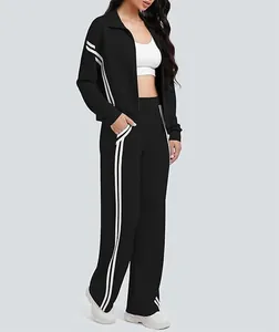 Detalle del chándal negro para mujer con rayas laterales y pantalones deportivos anchos.