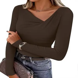 Close-up of slim fit brown long sleeve top with stylish asymmetrical v-neck design