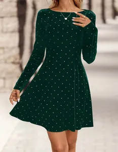 Close-up of elegant emerald green velvet mini dress with sparkling rhinestone polka dots