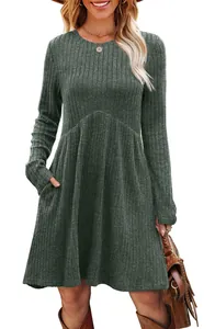 Close-up of dark green ribbed long sleeve dress with pockets and flared A-line hem