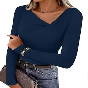 Detail of asymmetrical V-neck on navy blue slim-fit long sleeve top for women