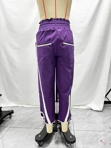 Back view detail of purple high-waist sports pants with white side stripes and elastic waist