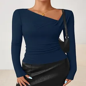 Detail view of navy blue slim fit top with asymmetrical V-neck and ruching