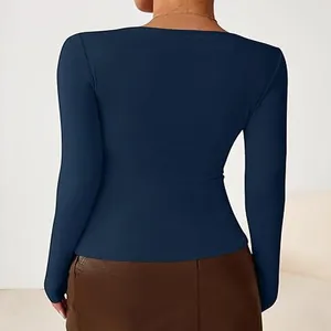 Detailed back view of a slim fit navy blue long sleeve top for women in minimalist style