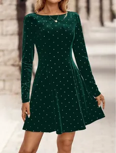 Detail of vintage dark green velvet mini dress with silver rhinestone polka dots.