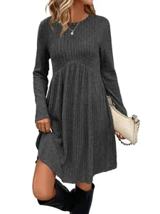 Close-up detail of a women's grey ribbed knit long sleeve crew neck dress on a model