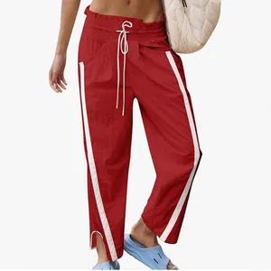 Red Y2K high waist sports pants for women featuring white side stripes and drawstring