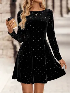 Detailed view of elegant black velvet mini dress with silver rhinestone polka dots.