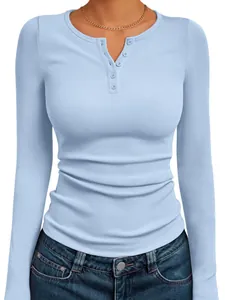 Macro view of light blue ribbed knit long sleeve Henley top featuring a buttoned neckline