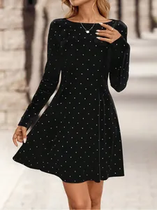 Elegant black velvet mini dress with sparkling rhinestones and long sleeves for winter.