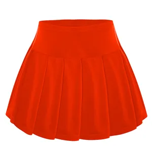 Clear front view of a bright orange pleated tennis skirt for children's activewear