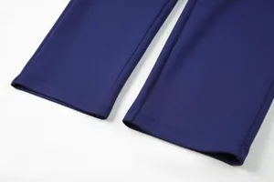 Close-up detail of navy blue sport pants showing mesh texture and cuff stitching