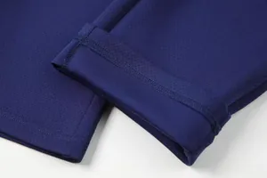 Close-up detail of the dark blue breathable mesh fabric and precise stitching on sports pants